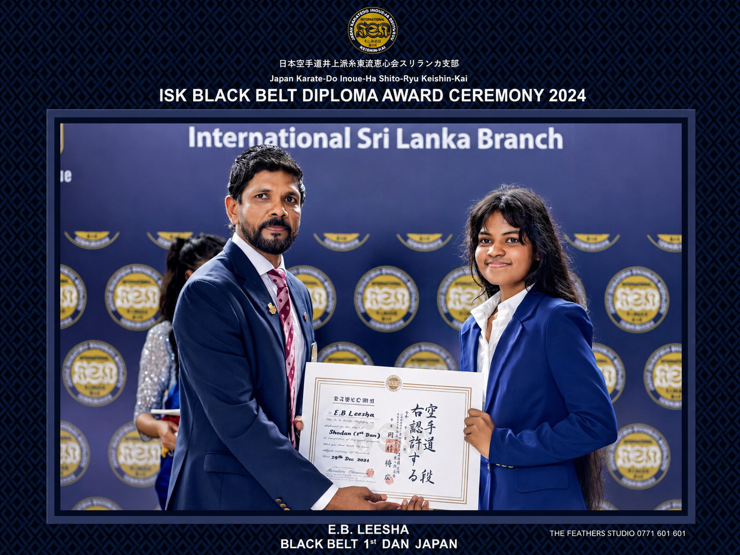 E. B. Leesha receiving her first dan black belt diploma