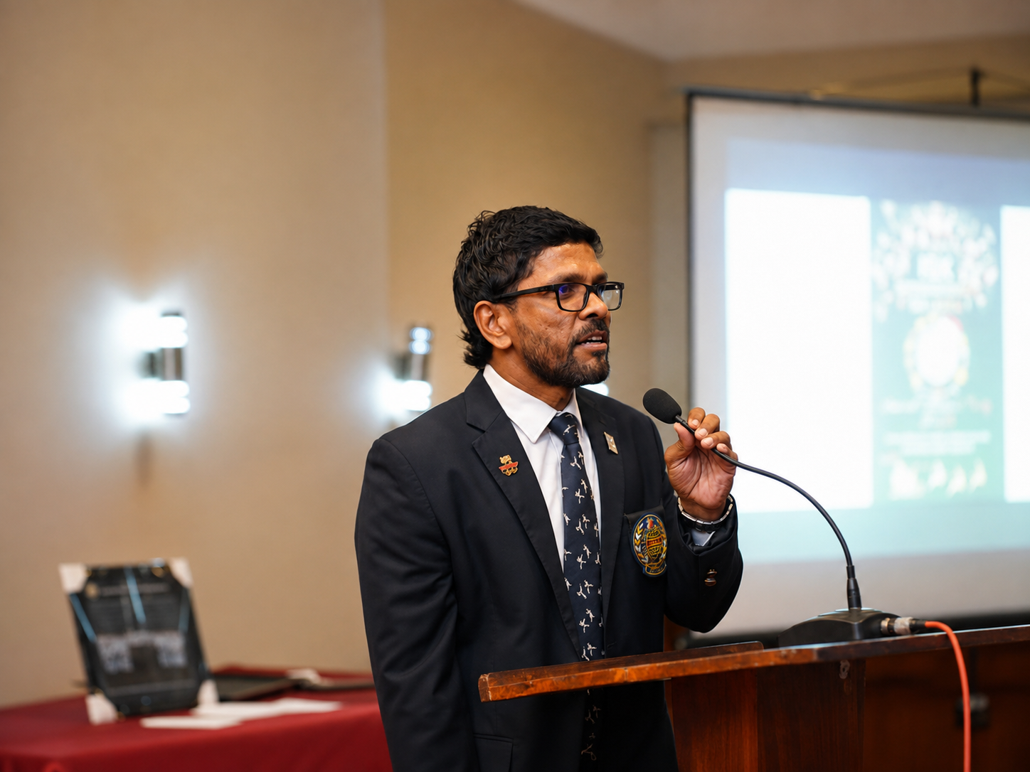 Karate official addressing guests at an award ceremony