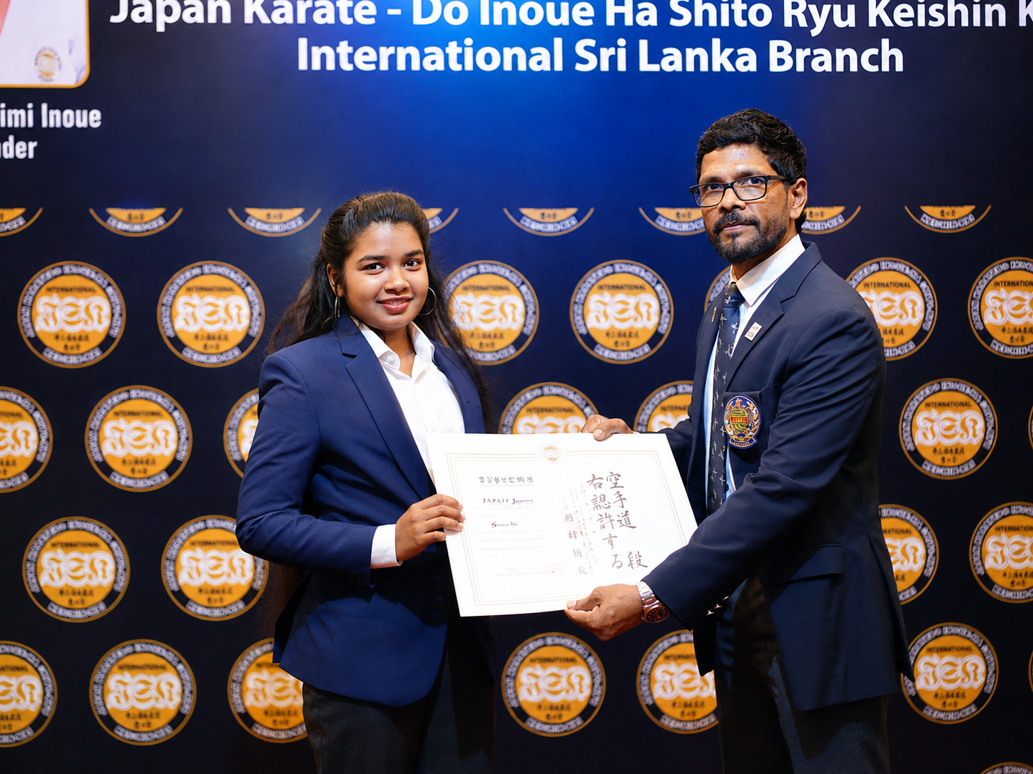 Karate student receiving her diploma at the black belt award ceremony