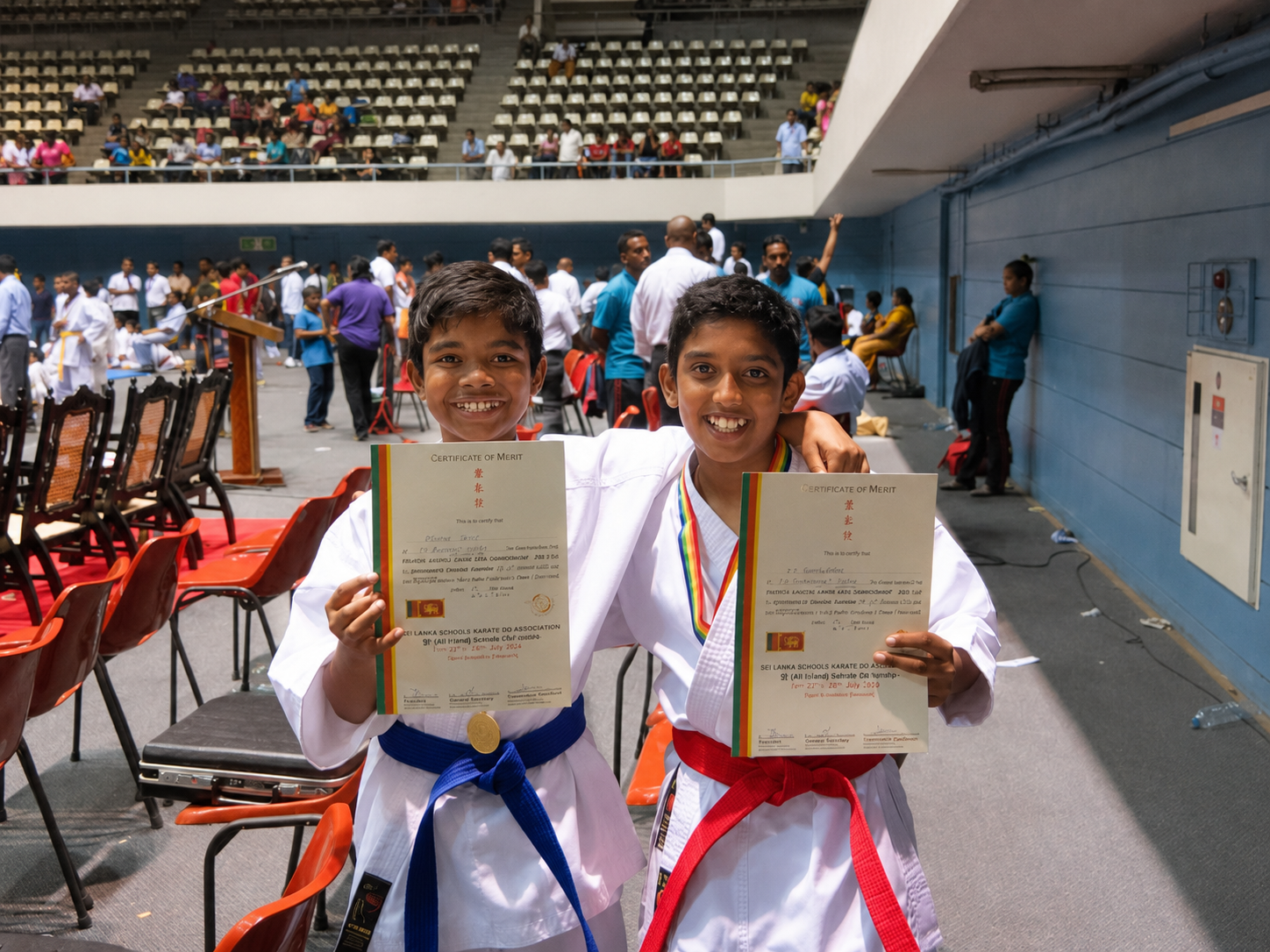 Two young karate competitors holding their medals and certificates