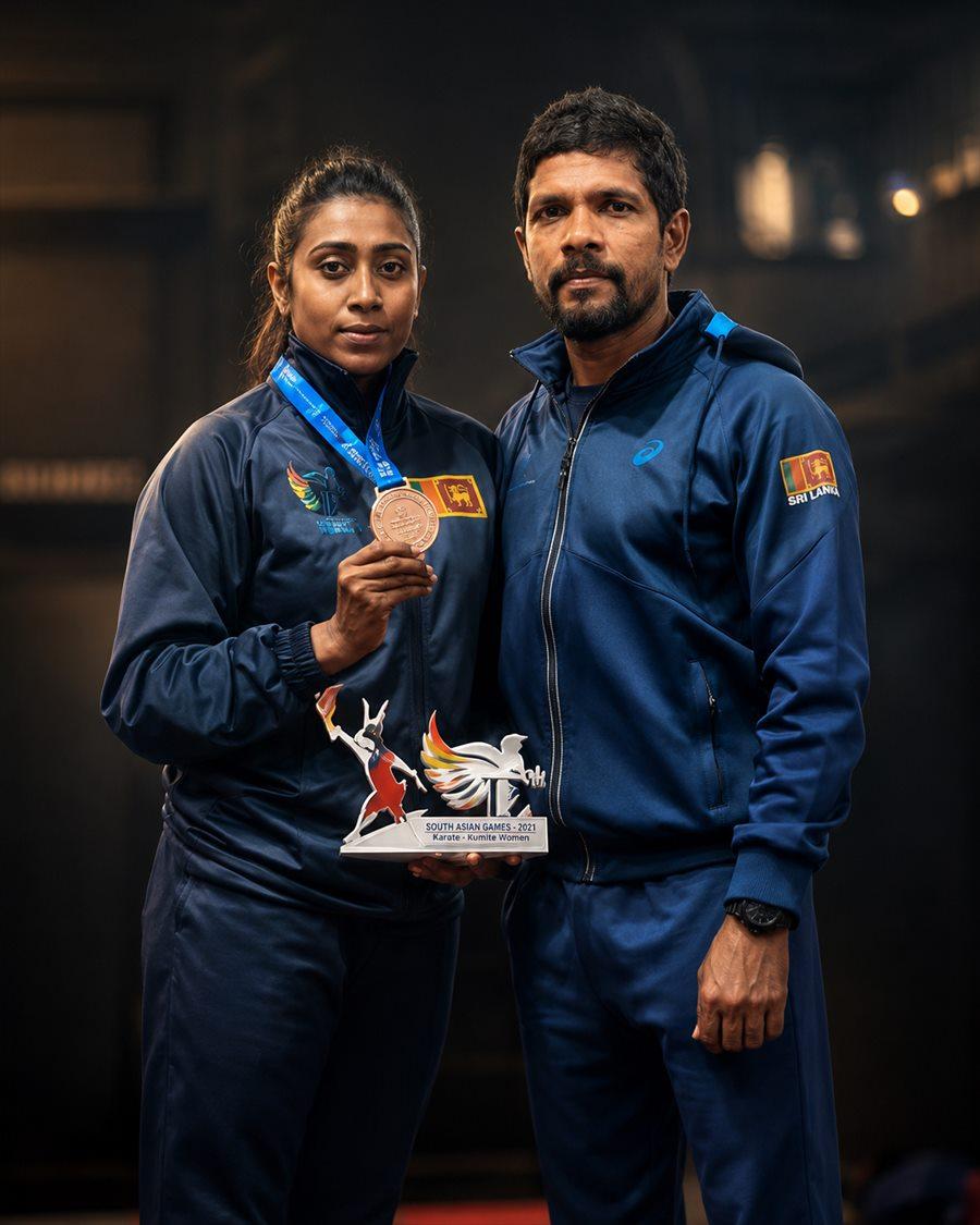 Shihan R.J. Edward with a medal-winning athlete and her South Asian Games trophy