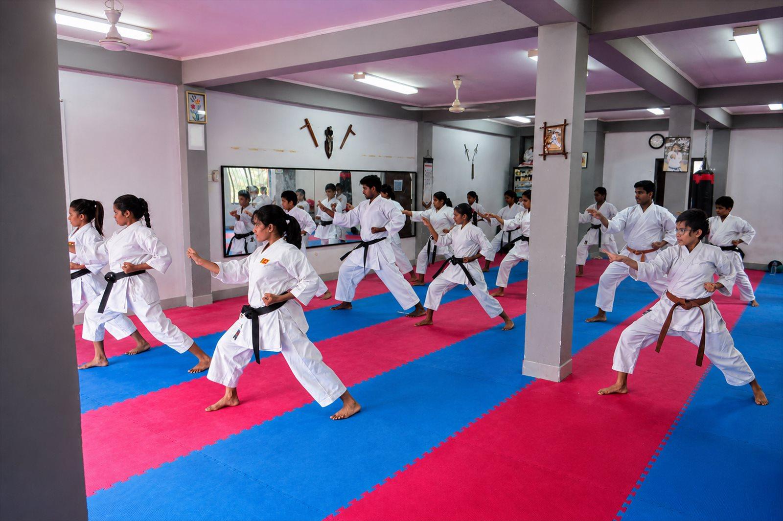 Students training together in synchronized stances at RJ Edward's Karate dojo