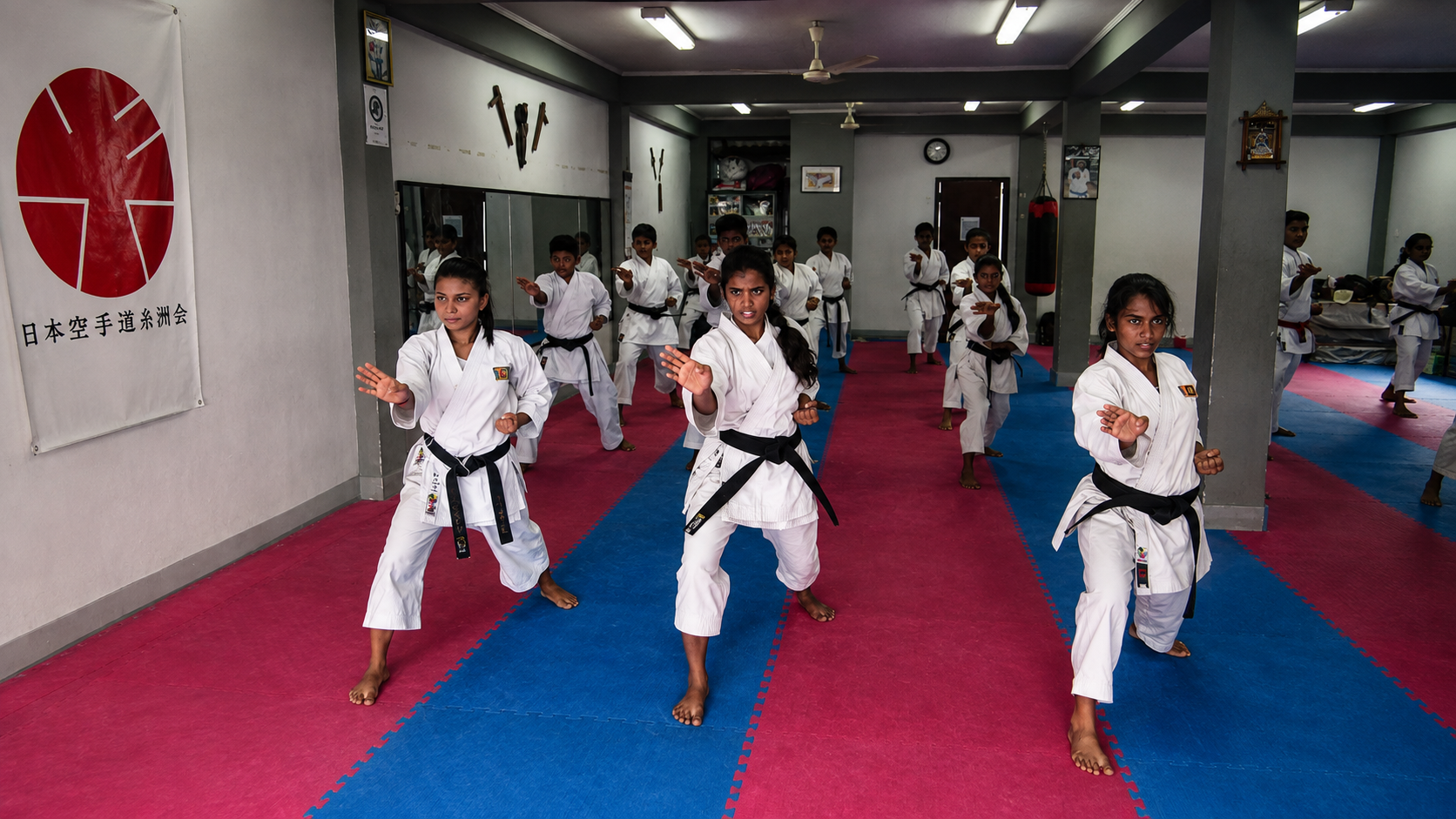 Karate students practising synchronized stances in the dojo